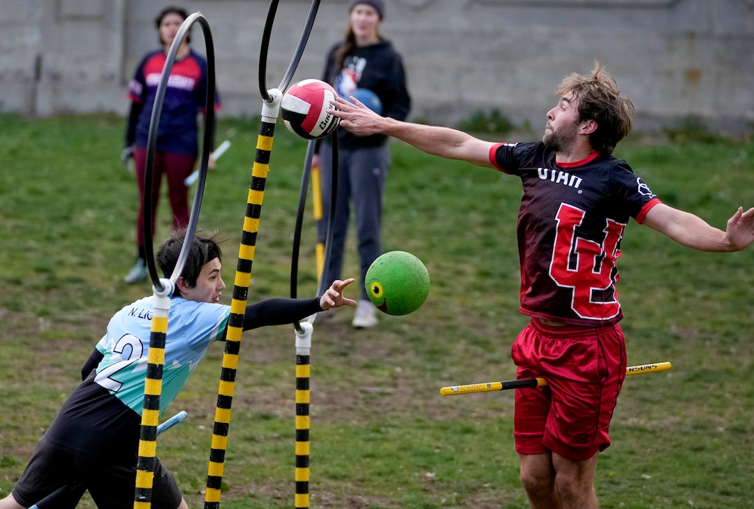 (Francisco Kjolseth | The Salt Lake Tribune) Nathan Liou uses a bludger (dodgeball) to try and tag Porter Birchum before he redirects a quaffle (volleyball) through a hoop while playing Quittich at Reservoir Park in Salt Lake City on Wednesday, April 13, 2022. 