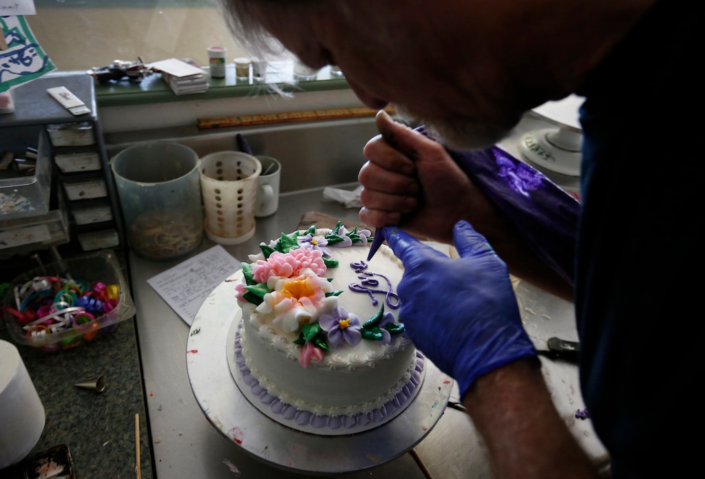 (Brennan Linsley | AP Photo) In this March 10, 2014 photo, Masterpiece Cakeshop owner Jack Phillips decorates a cake inside his store, in Lakewood, Colo. Phillips is appealing a recent ruling against him in a legal complaint filed with the Colorado Civil Rights Commission by a gay couple he refused to make a wedding cake for, based on his religious beliefs.