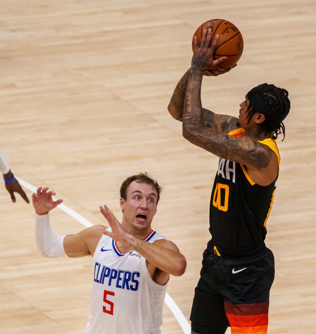 (Trent Nelson  |  The Salt Lake Tribune) Utah Jazz guard Jordan Clarkson (00) hits a three-pointer over LA Clippers guard Luke Kennard (5) as the Utah Jazz host the Los Angeles Clippers in a Game 5 matchup, NBA basketball in Salt Lake City on Wednesday, June 16, 2021.