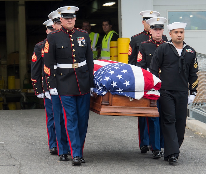 (Rick Egan  |  The Salt Lake Tribune)      The remains of Marine Pfc. Robert K. Holmes are carried from the Delta Air Cargo to a hearse for transportation to the mortuary.  Holmes died aboard the USS Oklahoma during the attack on Pearl Harbor. Friday, Aug. 17, 2018.