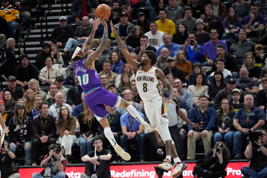 Utah Jazz guard Jordan Clarkson (00) shoots as New Orleans Pelicans forward Naji Marshall (8) defends during overtime of an NBA basketball game Thursday, Dec. 15, 2022, in Salt Lake City. (AP Photo/Rick Bowmer)
