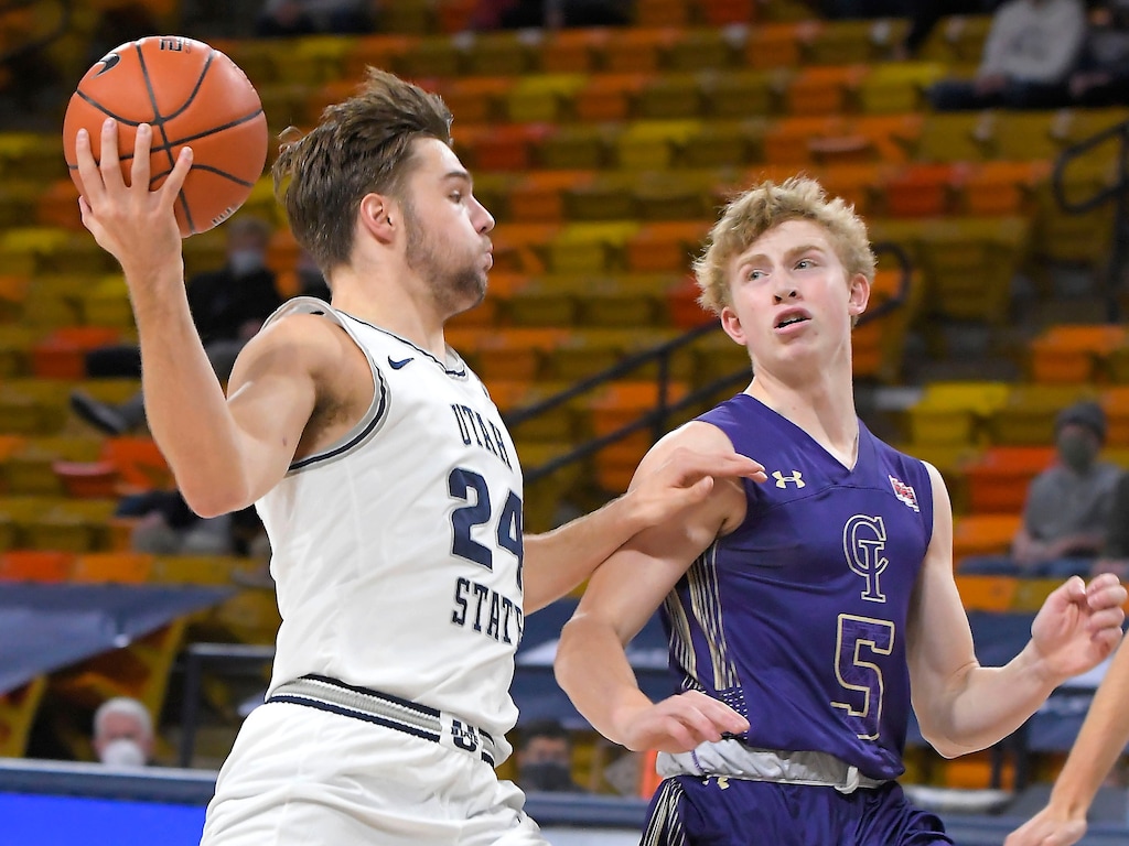 Utah State guard Rollie Worster (24) drives to the basket as College of Idaho guard Johnny Radford (5) defends during the first half of a college basketball game Tuesday, Dec. 8, 2020, in Logan, Utah. (Eli Lucero/The Herald Journal via AP, Pool)