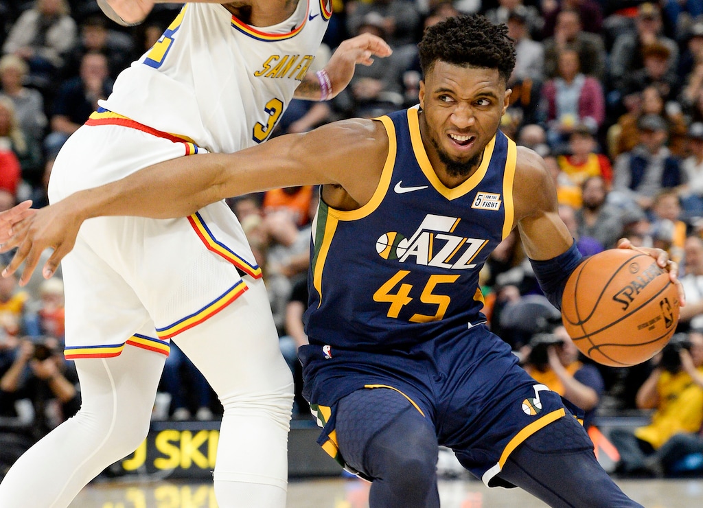 (Leah Hogsten  |  The Salt Lake Tribune) Utah Jazz guard Donovan Mitchell (45) drives around Golden State Warriors forward Marquese Chriss (32) as the Utah Jazz host the Golden State Warriors, Dec. 13, 2019 at Vivint Arena. 