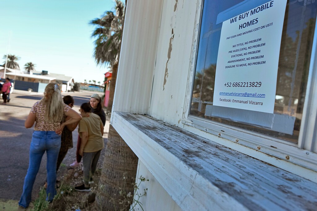 (Matt York | AP) Residents of the Periwinkle Mobile Home Park socialize outside their homes, Thursday, April 11, 2023, in Phoenix. Residents of the park are facing an eviction deadline of May 28 due to a private university's plan to redevelop the land for student housing.