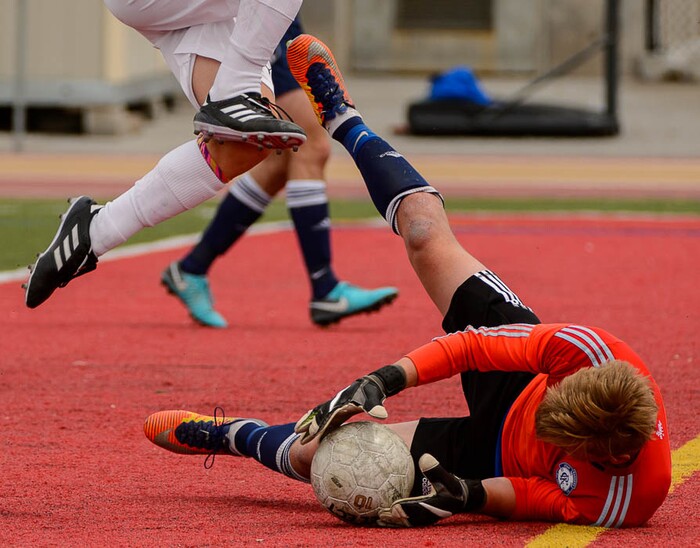 (Trent Nelson | The Salt Lake Tribune)  Judge Memorial's Jack Terrill (9) leaps over Maeser Prep goalkeeper John Hendrix during the Class 3A boys' soccer state quarterfinal between Judge Memorial and Maeser Prep in Salt Lake City, Saturday May 5, 2018.