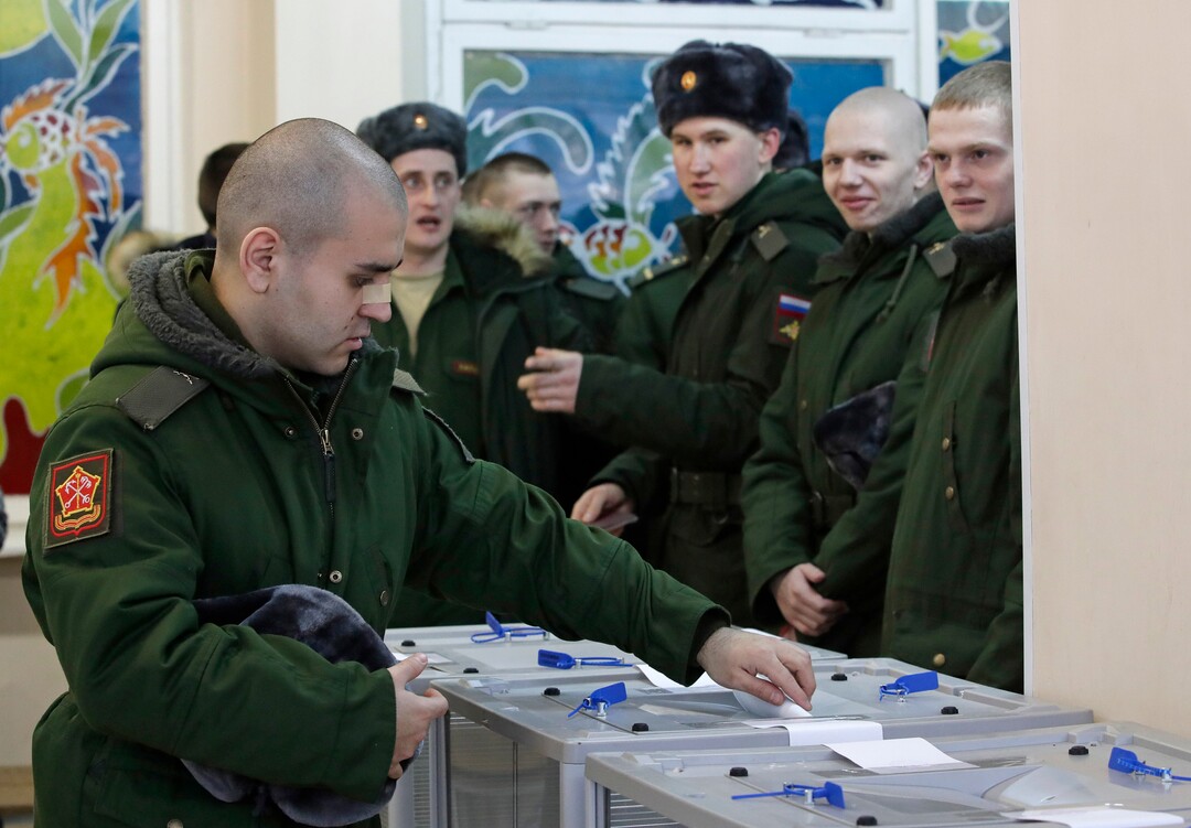 A Russian serviceman votes in the Russian presidential election in St. Petersburg, Russia, Sunday, March 18, 2018. Russians are voting in a presidential election in which Vladimir Putin is seeking a fourth term in the Kremlin. (AP Photo/Dmitri Lovetsky)