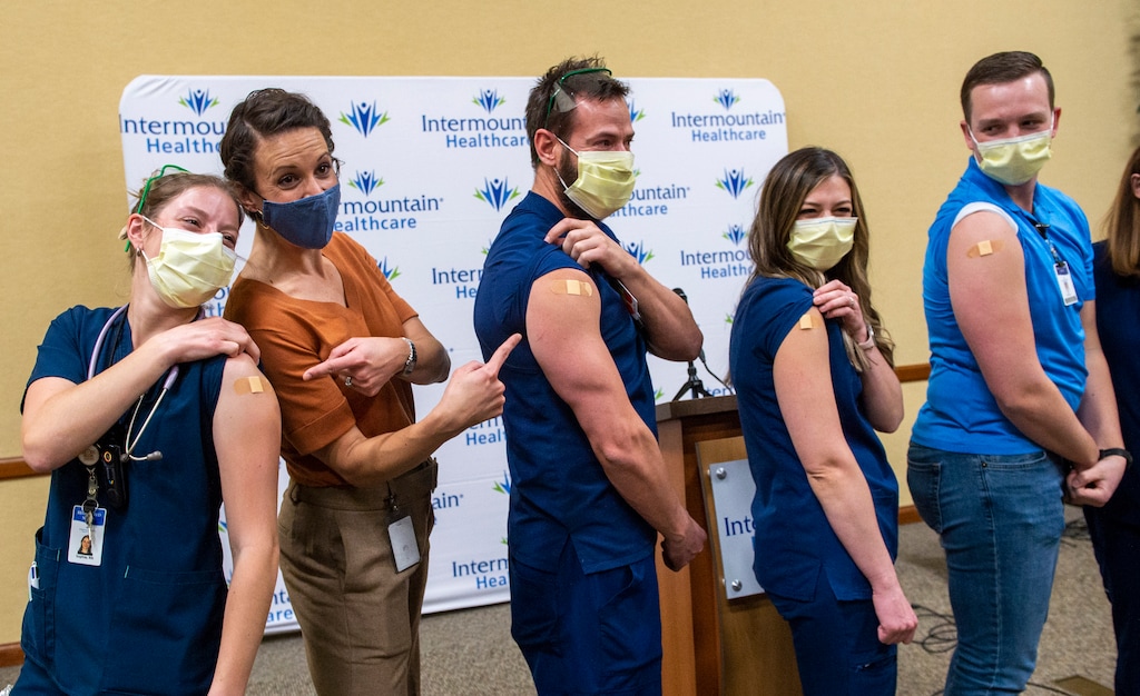 (Rick Egan | The Salt Lake Tribune) Nurse Sophie Woodbury, state epidemiologist Dr. Angela Dunn, and nurses Monte Roberts, Amanda Vicchrilli and William Brunt pose for a photo after the first Covid-19 vaccines were administered to the four nurses at LDS Hospital, on Tuesday, Dec. 15, 2020.