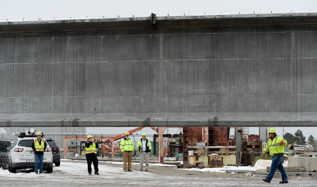 (Francisco Kjolseth  |  The Salt Lake Tribune)  UDOT gets ready to place some of the world's largest-ever bridge beams, and the largest in Utah state history with a span of 203 ft long and just over 8 ft tall, as crews load one on a truck following manufacturing at Forterra Structural Precast in Kearns on Tuesday, Dec. 11, 2018. A total of six beams will be installed in the technology corridor in Lehi later this week.