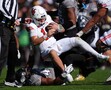 Utah quarterback Isaac Wilson, top, is tackled after a short gain by Colorado linebacker Nikhai Hill-Green in the first half of an NCAA college football game Saturday, Nov. 16, 2024, in Boulder, Colo. (AP Photo/David Zalubowski)