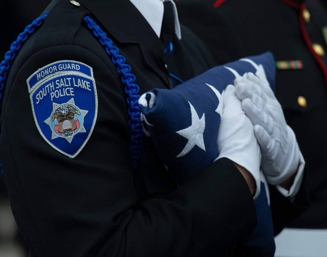 (Rick Egan  |  The Salt Lake Tribune)     Pall A member of the South Salt Lake Police Honor Guard holds the American flag, during the funeral for South Salt Lake police officer, David Romrell, at the Maverik Center in West Valley City, Wednesday, Dec. 5, 2018.