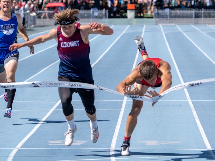 (Rick Egan | The Salt Lake Tribune)  Altamont's Ethan Hansen finishes in second place as Blake Barnes dives headfirst into the finish line for a first place finish in the 1A Boys 200 meter dash, at the State High School Championships at BYU, on Saturday, May 21, 2022.
