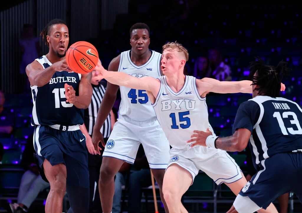 (Tim Aylen | Bahamas Visual Services via AP) Butler's Manny Bates, left, passes the ball as BYU's Richie Saunders reaches for it during an NCAA college basketball game in the Battle 4 Atlantis at Paradise Island, Bahamas, Thursday, Nov. 24, 2022.