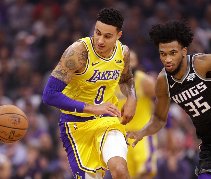 Los Angeles Lakers forward Kyle Kuzma, left, and Sacramento Kings forward Marvin Bagley III chase the ball during the first quarter of an NBA basketball game Saturday, Nov. 10, 2018, in Sacramento, Calif. (AP Photo/Rich Pedroncelli)