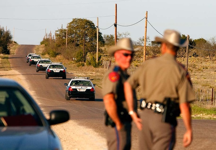 (Trent Nelson | The Salt Lake Tribune)
Eldorado, Texas - As law enforcement officials fearing a Waco-type incident prepare to breach the polygamous sect's temple at the YFZ Ranch, Texas State Troopers speed through a roadblock, en route to reinforce the assault which would meet with only minimal non-violent resistance.