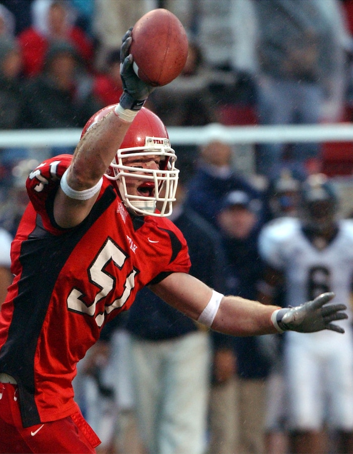 (Tribune File Photo)  Utah's #51 Brooks Bahr reacts after Utah recovers a BYU fumble during the rivalry game on November 23, 2002. 