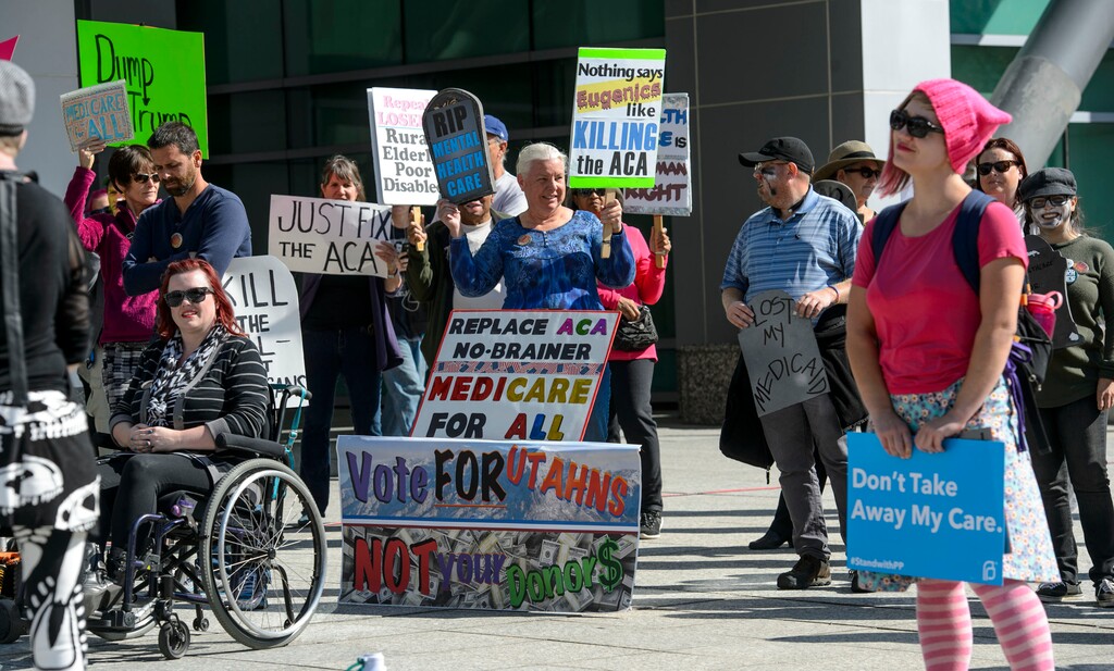 (Steve Griffin  |  The Salt Lake Tribune)  Supporters listen to  activist Psarah Johnson as she speaks during a health care rally at the William F. Bennett Federal Building in Salt Lake City Monday September 25, 2017.