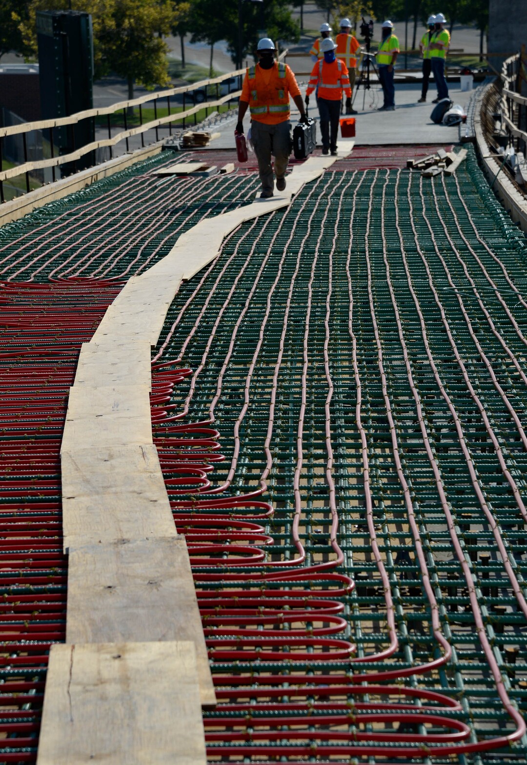 (Francisco Kjolseth  |  The Salt Lake Tribune) UDOT gives a tour of the state’s new longest pedestrian bridge on Thursday, August 20, 2020, connecting Utah Valley University in Orem to student housing and the community on the West side of I-15. Crews are finishing up an extensive hydronic heating system that will pump warm water to keep the bridge clear of snow in the winters, as it gets ready to pour concrete for the walking surface. UDOT will close I-15 in both directions this weekend for work on the nearly 1,000 foot bridge that is 15 feet wide to accommodate pedestrians, cyclists and scooters. Elevators and stairs with small ramps to push up bicycles will be on each side of the bridge.