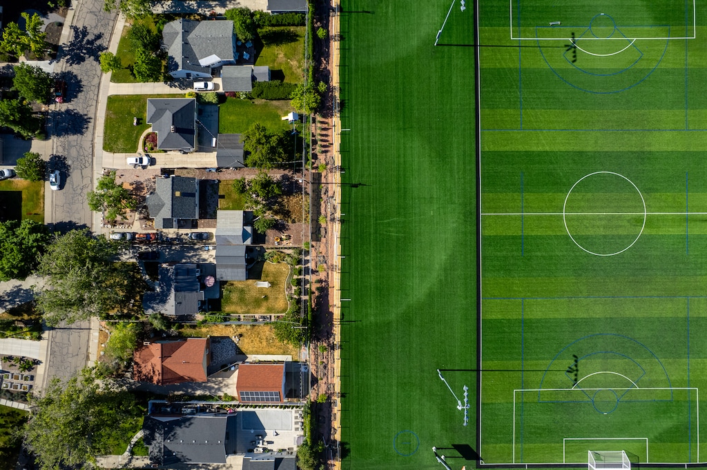 (Trent Nelson  |  The Salt Lake Tribune) The artificial turf field at Rosslyn Heights Sports Complex and residential homes in Salt Lake City on Wednesday, June 10, 2026.