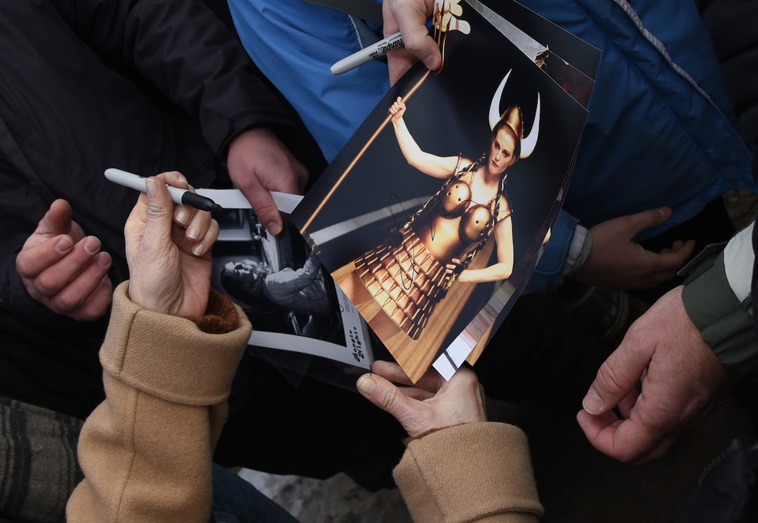 (Francisco Kjolseth  |  The Salt Lake Tribune)  Julianne Moore autographs a photo of herself during her performance on the film The Big Lebowski as the Sundance Film Festival kicks into high gear along Main street in Park City on Friday, Jan. 25, 2019.