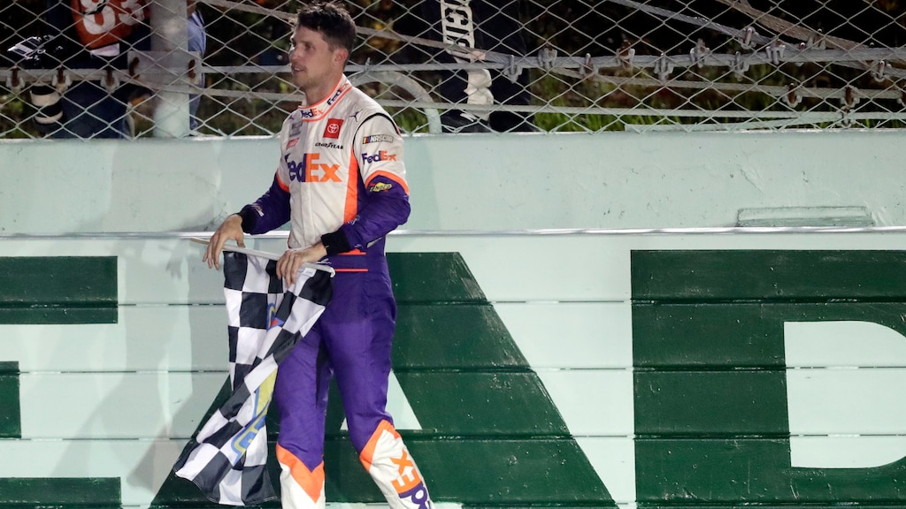 Denny Hamlin celebrates with the checkered flag after winning a NASCAR Cup Series auto race Sunday, June 14, 2020, in Homestead, Fla. (AP Photo/Wilfredo Lee)