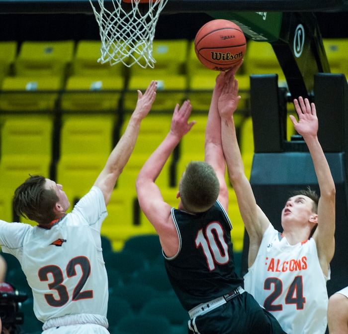 (Rick Egan  |  The Salt Lake Tribune)   Bountiful Braves Brig Willard (10) shoots as Skyridge Falcons Joe White (32) and Trevon Snoddy (24) defend, in 5A basketball playoff action between the Bountiful Braves and Skyridge Falcons, at the UCCU Center in Orem, Monday, Feb. 26, 2018.