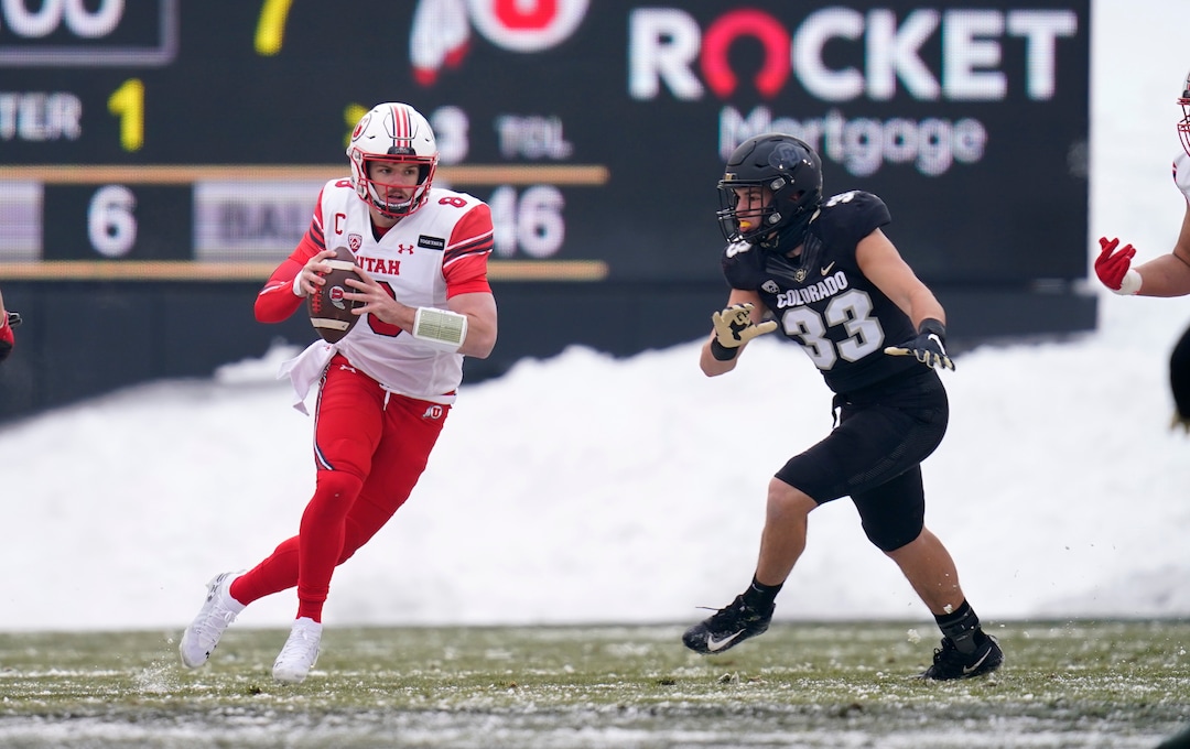 Utah quarterback Jake Bentley, left, is pursued by Colorado linebacker Joshka Gustav in the first half of an NCAA college football game Saturday, Dec. 12, 2020, in Boulder, Colo. (AP Photo/David Zalubowski)