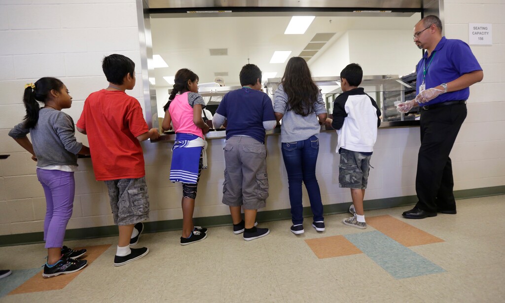 (Eric Gay | The Associated Press) In this Sept. 10, 2014, file photo, detained immigrant children line up in the cafeteria at the Karnes County Residential Center, a detention center for immigrant families, in Karnes City, Texas. The Trump administration stopped using the center to hold parents and children in March 2019. It’s cut back on family detention even as it complains it has to “catch and release” migrant families, many of them Central American parents and children who seek asylum.