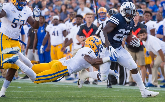 (Rick Egan  |  The Salt Lake Tribune)    Brigham Young Cougars running back Squally Canada (22) gets past McNeese State Cowboys defensive lineman Cody Roscoe (57) and McNeese State Cowboys defensive back Trent Jackson (9), in football action Brigham Young Cougars vs McNeese State Cowboys at Lavell Edwards Stadium, Saturday, Sept. 22, 2018.


