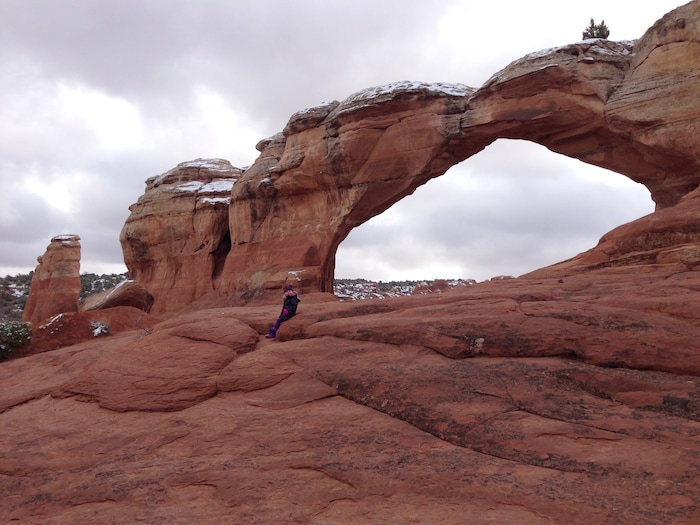 (Erin Alberty  |  The Salt Lake Tribune) 

A hiker takes a rest at Broken Arch in Arches National Park.