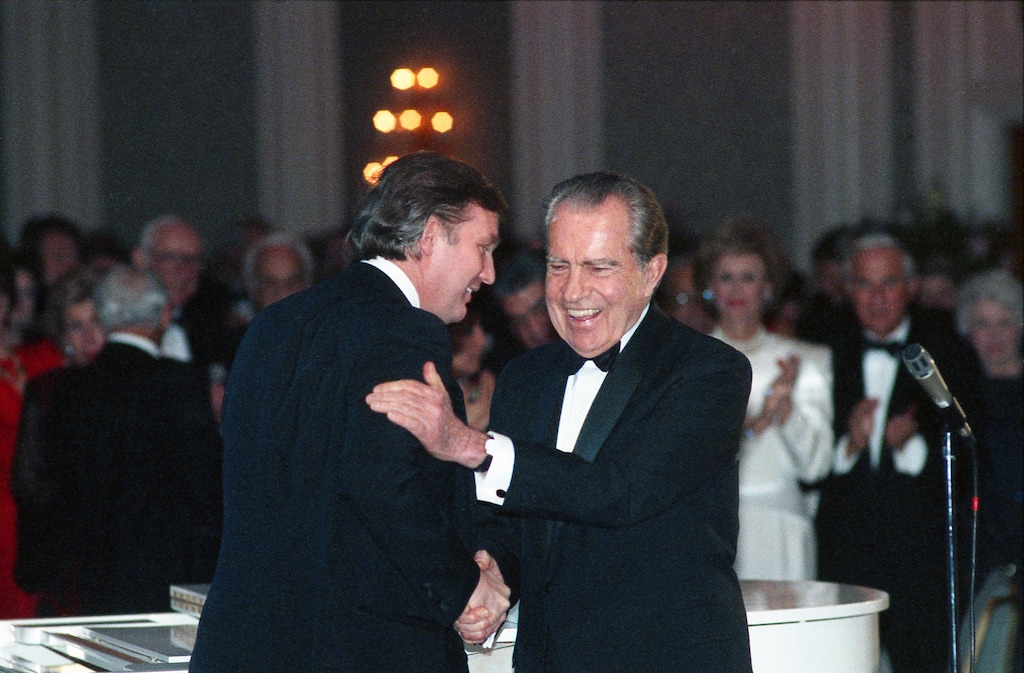 In this March 11, 1989, photo Donald Trump shakes hands with former President Richard Nixon at a tribute gala to Nellie Connally at the Westin Galleria ballroom in Houston, Texas. (Richard Carson/Houston Chronicle via AP)