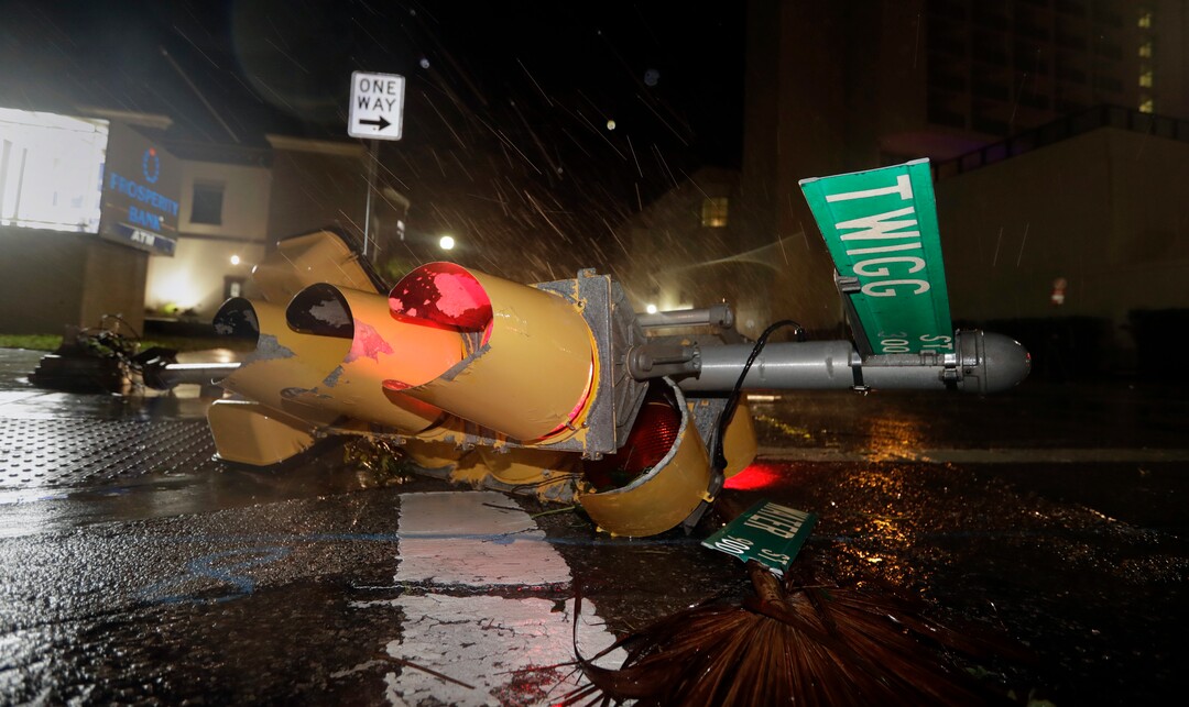 (Eric Gay | The Associated Press) A traffic signal topped by the winds of Hurricane Harvey lies in an intersection of downtown Corpus Christi, Texas, Saturday, Aug. 26, 2017.  Harvey has been further downgraded to a Category 1 hurricane as it churns slowly inland from the Texas Gulf Coast, already depositing more than 9 inches of rain in South Texas.