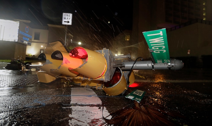 (Eric Gay | The Associated Press) A traffic signal topped by the winds of Hurricane Harvey lies in an intersection of downtown Corpus Christi, Texas, Saturday, Aug. 26, 2017.  Harvey has been further downgraded to a Category 1 hurricane as it churns slowly inland from the Texas Gulf Coast, already depositing more than 9 inches of rain in South Texas.