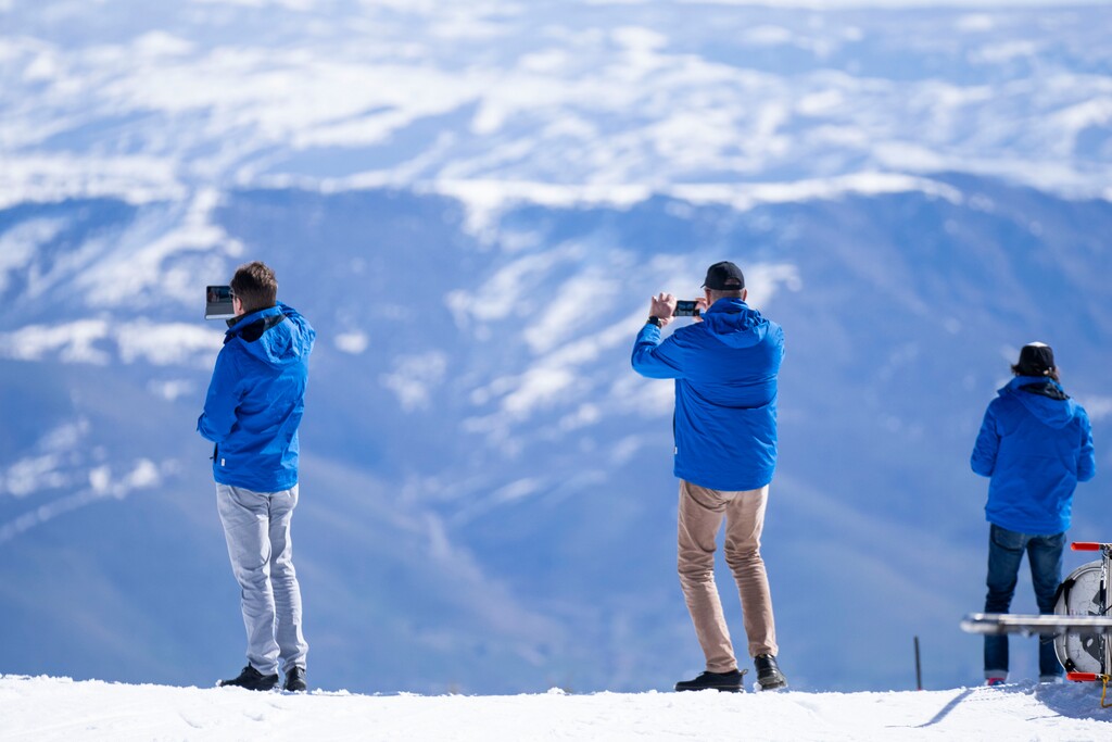 (Rick Egan | The Salt Lake Tribune)   Members of the International Olympic Committee and U.S. Olympic & Paralympic leaders snap photos of the view, as they visit Snowbasin Ski Resort, on Friday, April 12, 2024.