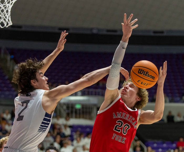 (Rick Egan | The Salt Lake Tribune) The Corner Canyon Chargers Isaac Neibaur blocks a shot by Ashton Wallace in their win over the American Fork Cavemen, for  the Boys 6A State Championship at Weber State, on Saturday, March 4, 2023.