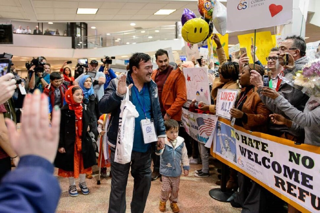 (Photo courtesy of Catholic Community Services) Refugees arrive at the Salt Lake City airport with volunteers from Catholic Community Services.