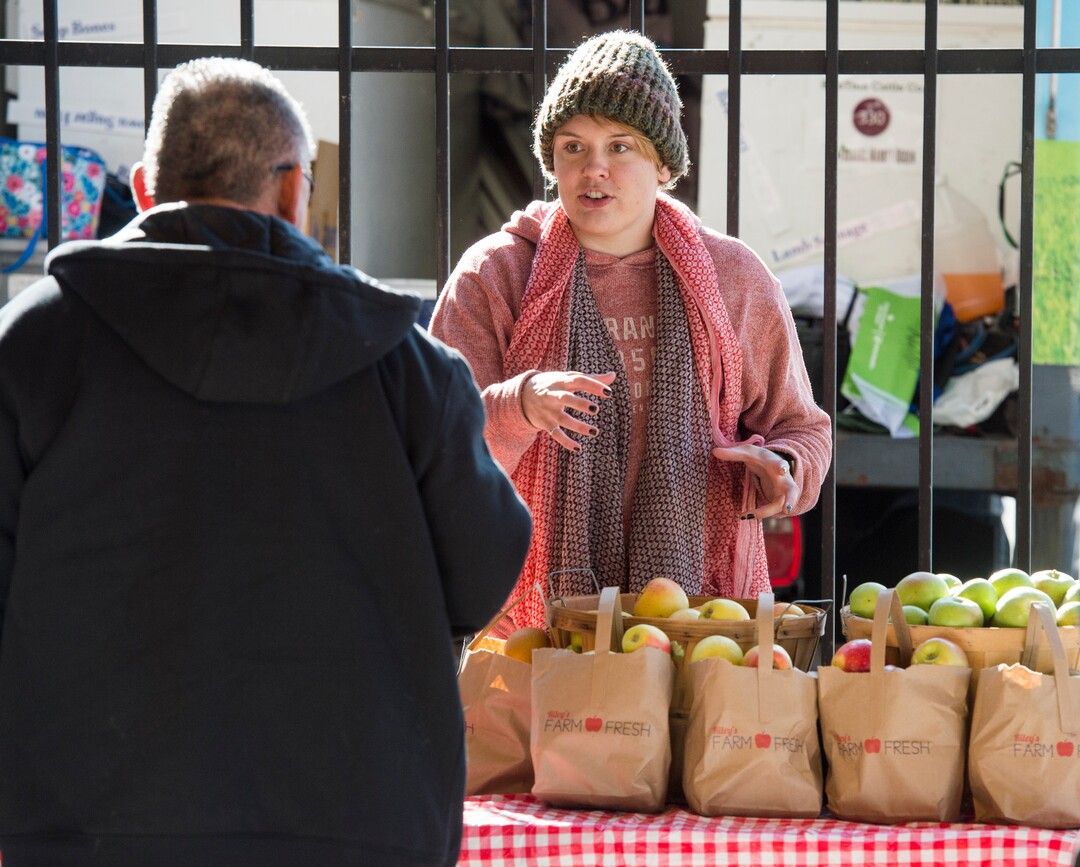 (Rick Egan  |  The Salt Lake Tribune)     Michelle Bennett sells apples for Riley's Farms, at the Downtown Winter Market which opened today at the Rio Grande Depot, Saturday, Nov. 10, 2018.
