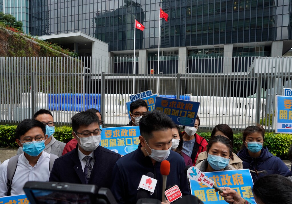 (Vincent Yu | AP) Pro-China supporters wearing masks urge the government to deliver masks to local people during a protest in Hong Kong, Tuesday, Feb. 4, 2020. Hong Kong on Tuesday reported its first death from a new virus, a man who had traveled from the mainland city of Wuhan that has been the epicenter of the outbreak.