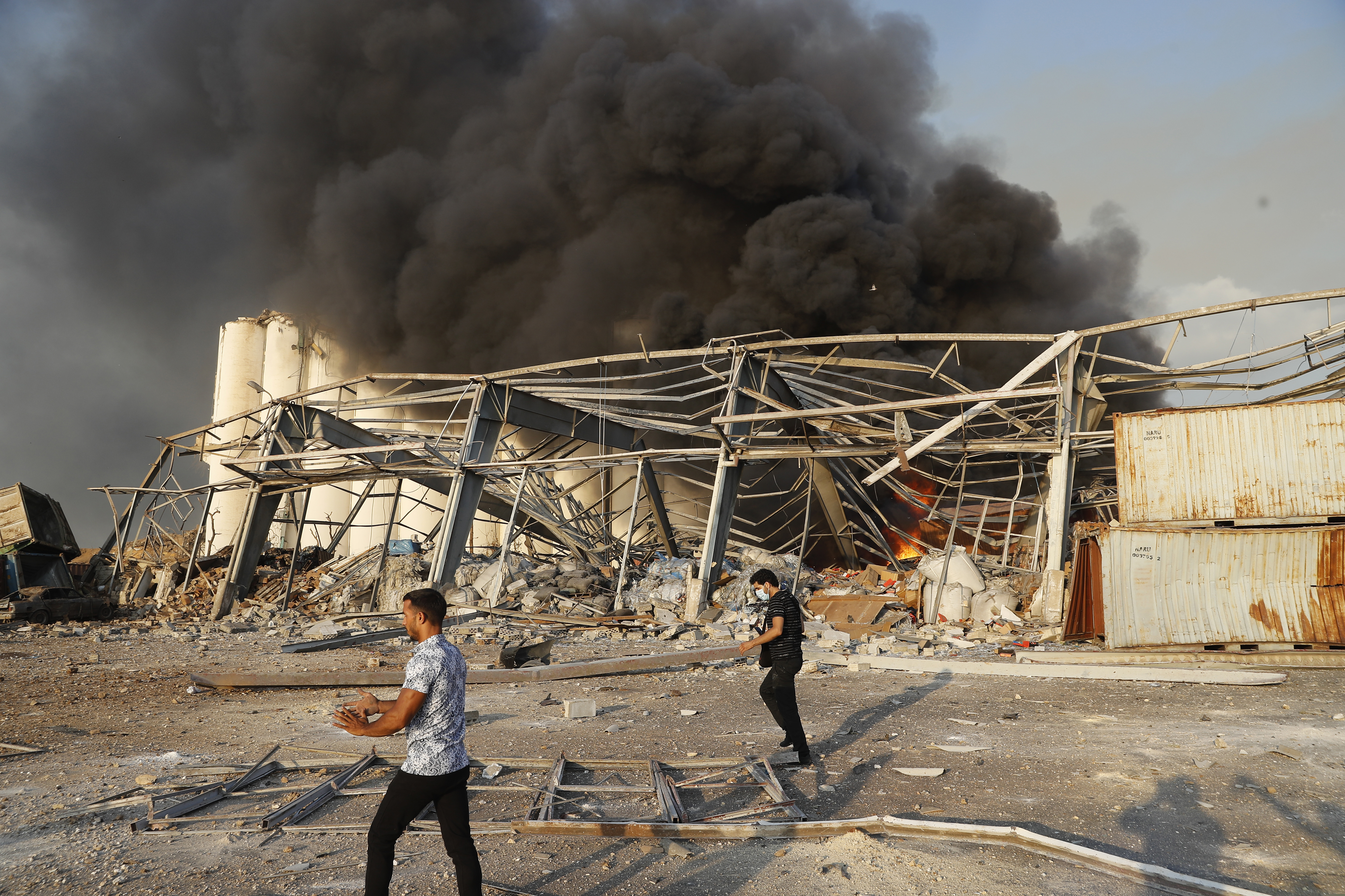 Lebanese security officers arrive at the scene of an explosion that hit the seaport of Beirut, Lebanon, Tuesday, Aug. 4, 2020. Massive explosions rocked downtown Beirut on Tuesday, flattening much of the port, damaging buildings and blowing out windows and doors as a giant mushroom cloud rose above the capital.  (AP Photo/Hussein Malla)