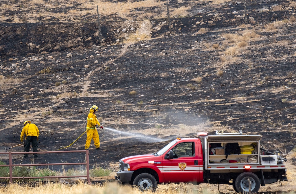 (Rick Egan | The Salt Lake Tribune) Firefighters spray hot spots on a wildfire fire in Herriman on Friday, July 16, 2021. Rep. Blake Moore, R-Utah, is pushing a federal bill to help in the battle against wildfires.