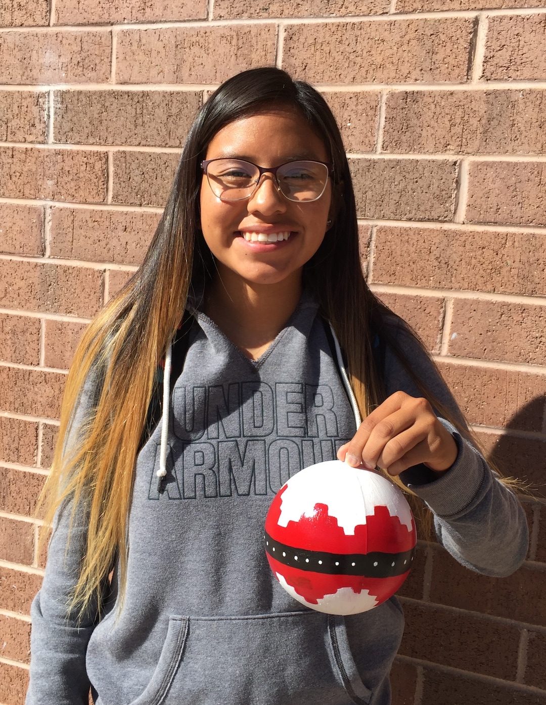(Photo courtesy of Georgiana Simpson) A student at Whitehorse High School holds an ornament she painted.