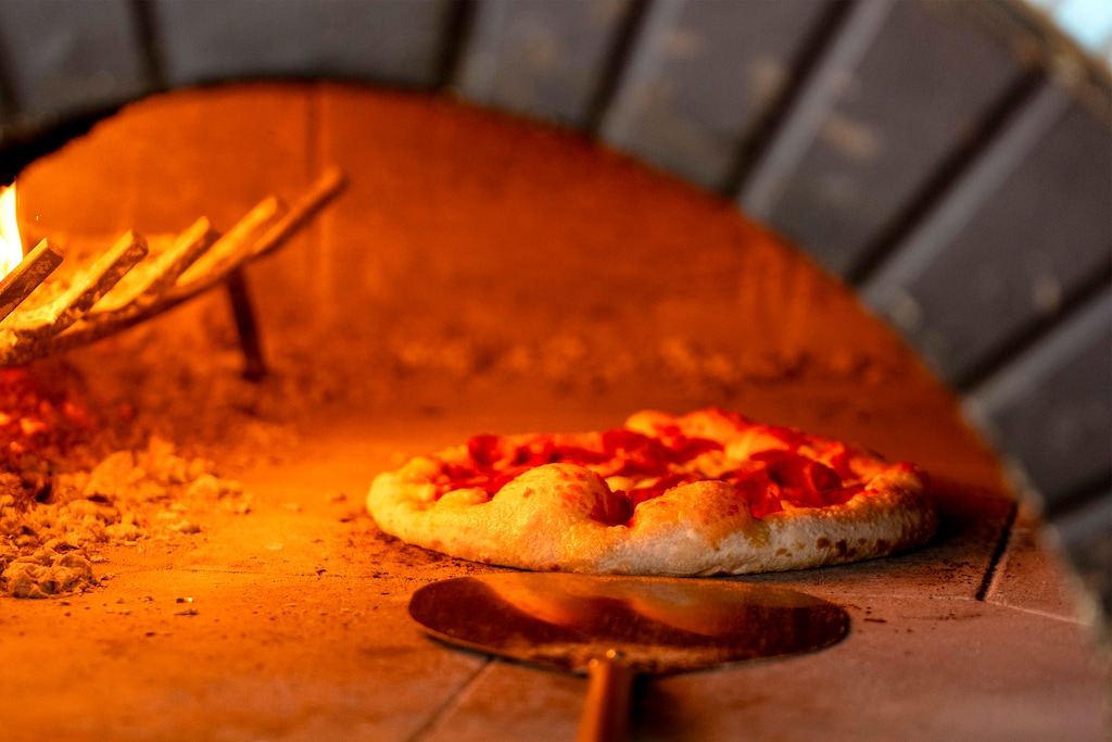 (Rick Egan | The Salt Lake Tribune) A pizza cooks at the Pizza Bar, on Regent Street, on Friday, July 25, 2025.