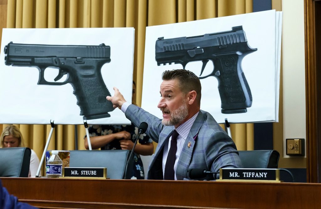 Rep. Greg Steube, R-Fla., compares different models of firearms as the House Judiciary Committee holds a markup on the Assault Weapons Ban of 2021, at the Capitol in Washington, Wednesday, July 20, 2022. (AP Photo/J. Scott Applewhite)