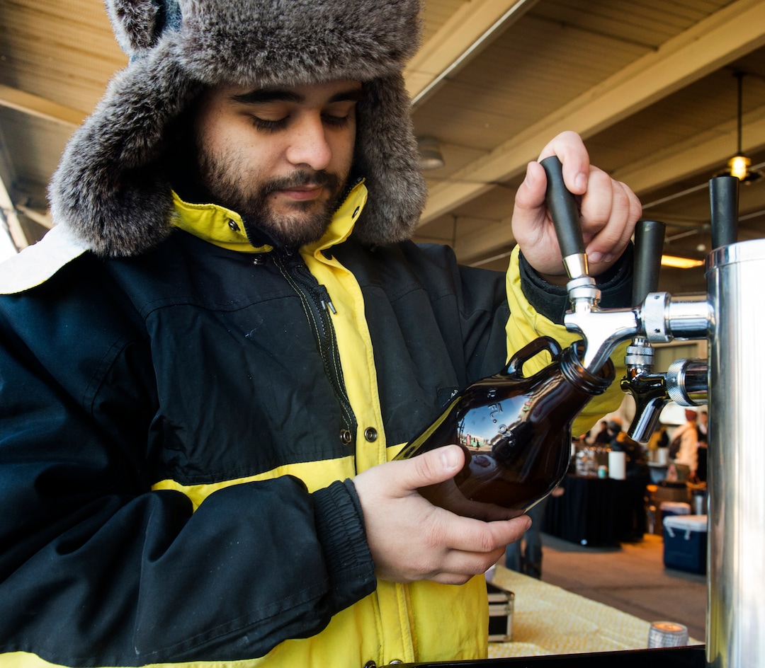 (Rick Egan  |  The Salt Lake Tribune)      Andres Escobar pours a bottle of Ginger Beer, at the Downtown Winter Market which opened today at the Rio Grande Depot, Saturday, Nov. 10, 2018.