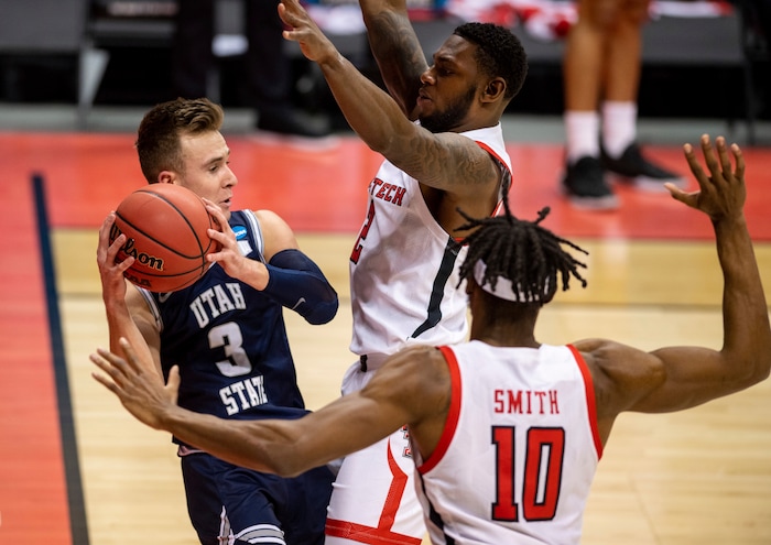 (Doug McSchooler | AP) Utah State guard Steven Ashworth (3), left, is trapped along the baseline by Texas Tech guard Jamarius Burton (2) and forward Tyreek Smith (10) during the first half of a first round game in the NCAA men's college basketball tournament, Friday, March 19, 2021, in Bloomington, Ind.