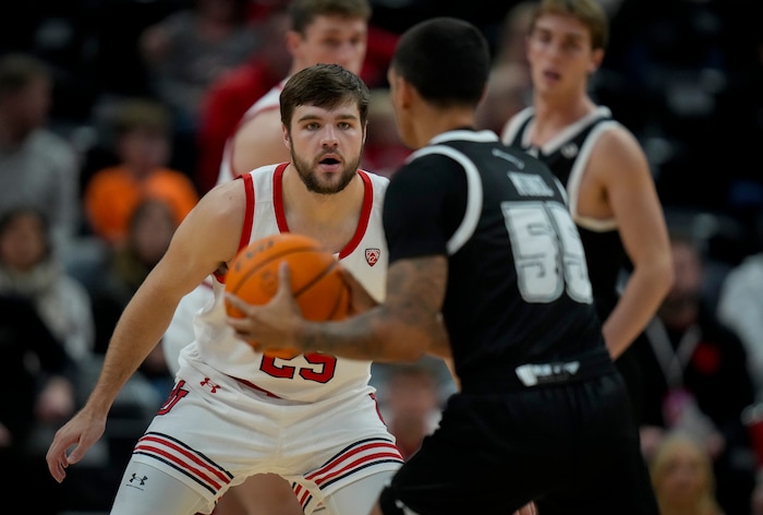 (Bethany Baker  |  The Salt Lake Tribune) Utah Utes guard Rollie Worster (25) defends as Hawaii Warriors guard Juan Munoz (55) looks to pass the ball at the Delta Center in Salt Lake City on Thursday, Nov. 30, 2023.