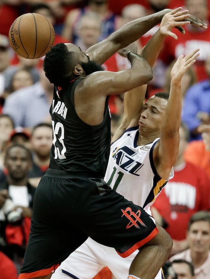 Houston Rockets guard James Harden, left, is fouled by Utah Jazz guard Dante Exum during the second half in Game 2 of an NBA basketball second-round playoff series Wednesday, May 2, 2018, in Houston. (AP Photo/Eric Christian Smith)
