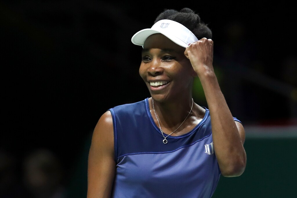 Venus Williams of the United States celebrates after beating Caroline Garcia of France during their semifinal match at the WTA tennis tournament in Singapore, on Saturday, Oct. 28, 2017. (AP Photo/Yong Teck Lim)