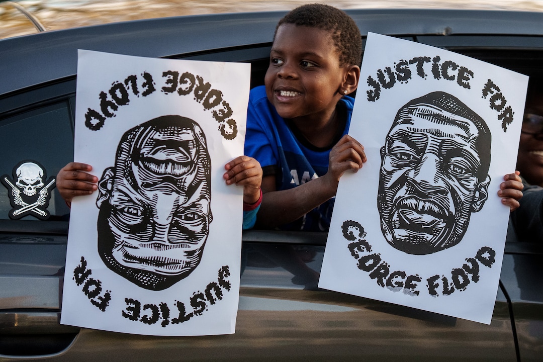 (Trent Nelson  |  The Salt Lake Tribune) Jamari and Jahavion Butoyi hold signs as people march in Salt Lake City on Tuesday, April 20, 2021 to mark the conviction of Derek Chauvin for the murder of George Floyd.