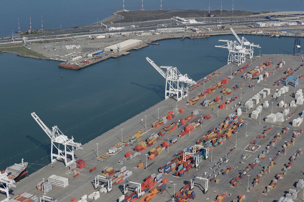 (AP Photo/Eric Risberg, File, File) This Feb. 5, 2016, file photo shows the former Oakland Army Base pier at left and the Port of Oakland at lower right in Oakland, Calif.