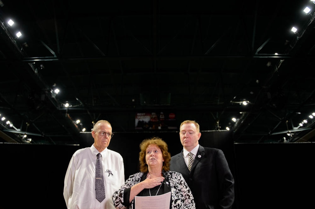 (Trent Nelson | The Salt Lake Tribune)  Julie Egelund reads a statement about her sister Jill Robinson, a West Valley City code-enforcement officer killed on the job last week prior to funeral services at the Maverik Center in West Valley City on Friday Aug. 17, 2018. At left is Julie's husband Kent Egelund, at right her brother Jaren Robinson.